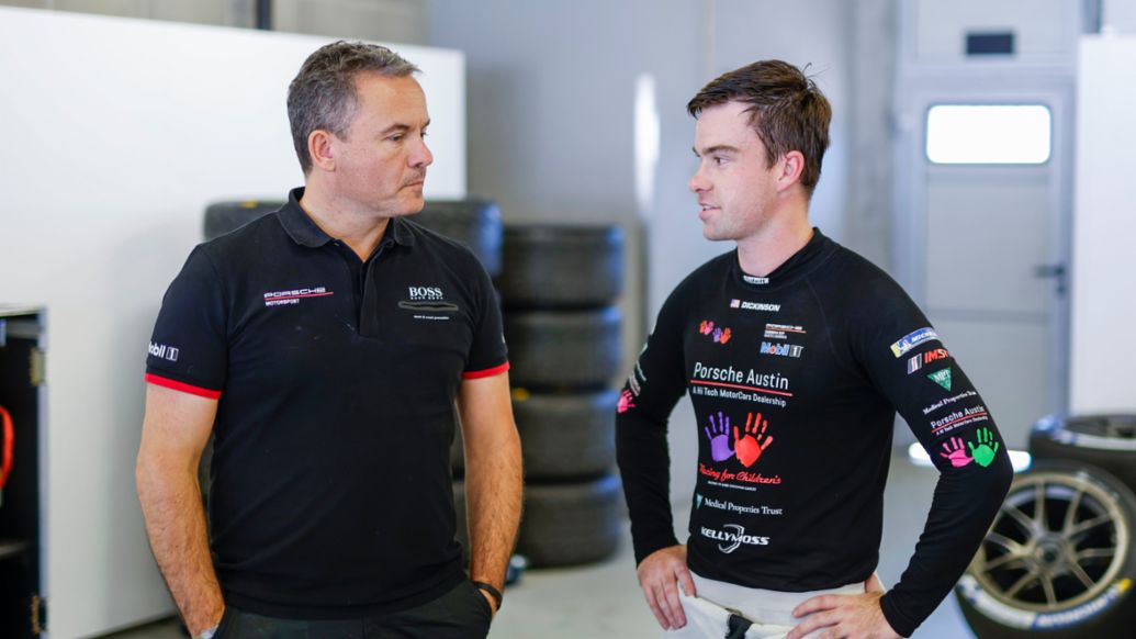 Porsche Carrera Cup North America champion Riley Dickinson talks with Juniors coach Sascha Maassen