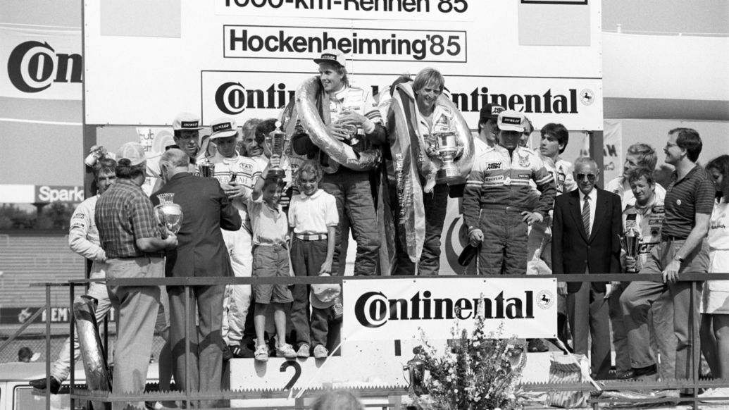 Hans-Joachim Stuck, Derek Bell (l-r), victory ceremony at the 1000 km Hockenheim, 1985, Porsche AG
