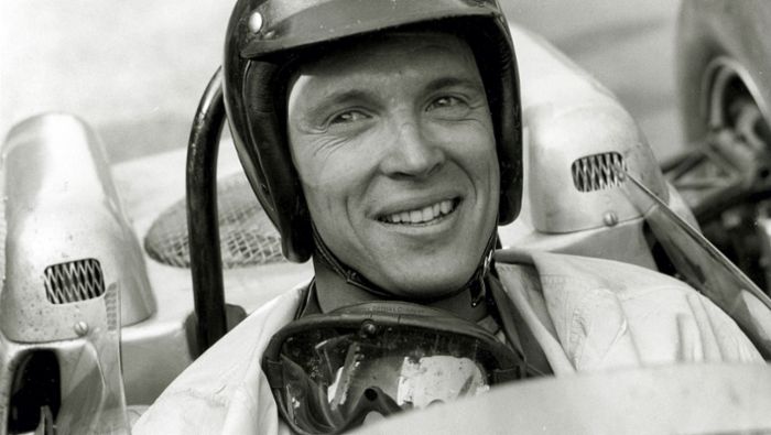 race car driver sprays champagne up dress Porsche mourns the death of Dan Gurney