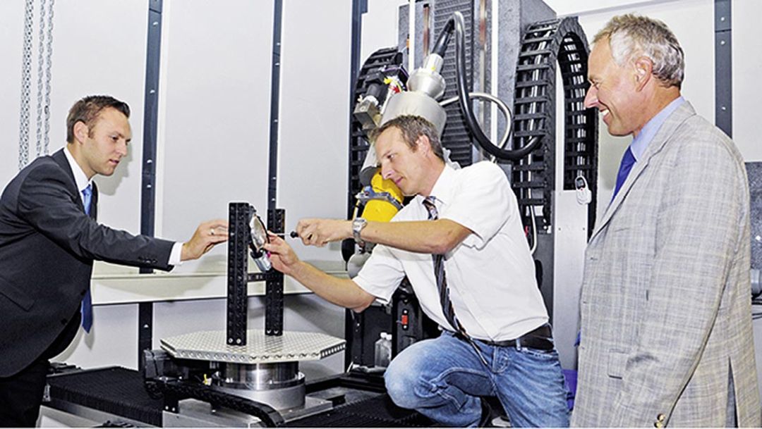Ingo Vater, Hendrik Hoehe und Uwe-Alexander Mueller, Weissacher CT specialists, l.-r., inside a large computer tomography, 2014, Porsche AG