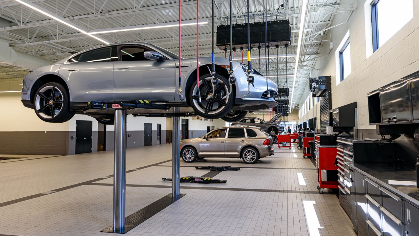 A Taycan Turbo being serviced at one of 13 lift bays at Porsche Service Center South Atlanta, 2021, PCNA