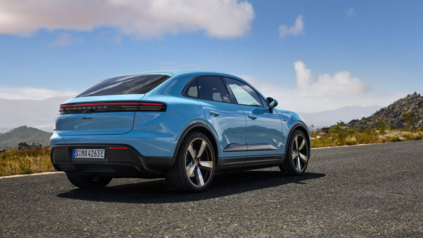 Official Porsche image of a Macan Electric parked on a mountain road